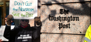 Jeff Bezos promove demissões em massa no Washington Post, afetando um terço da equipe e gerando protestos. Foto: Participante do comício "Salve o Post" segura cartaz em frente à sede do jornal - NewsGuild-CWA